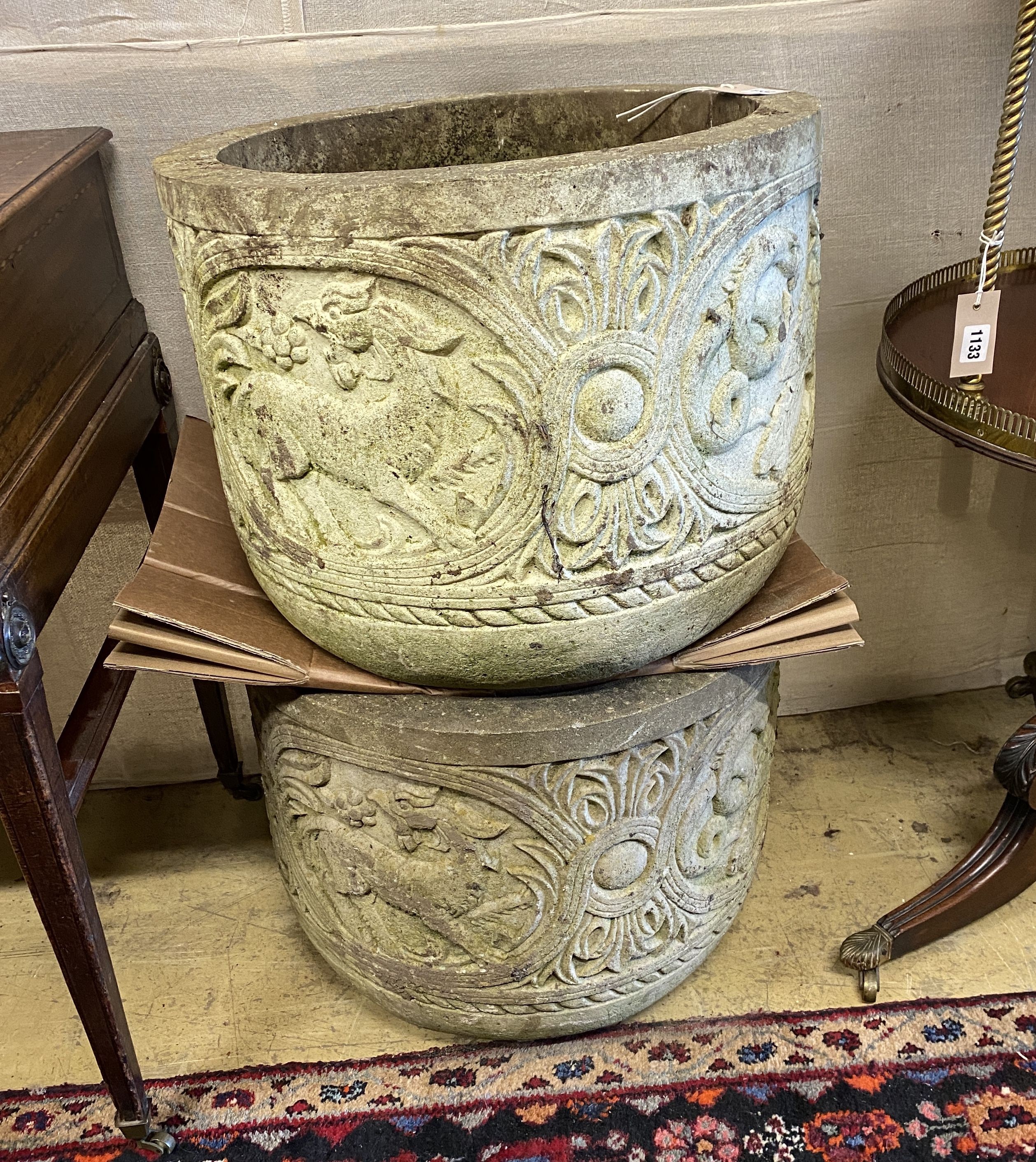 A pair of reconstituted stone circular garden planters, diameter 54cm, height 42cm
